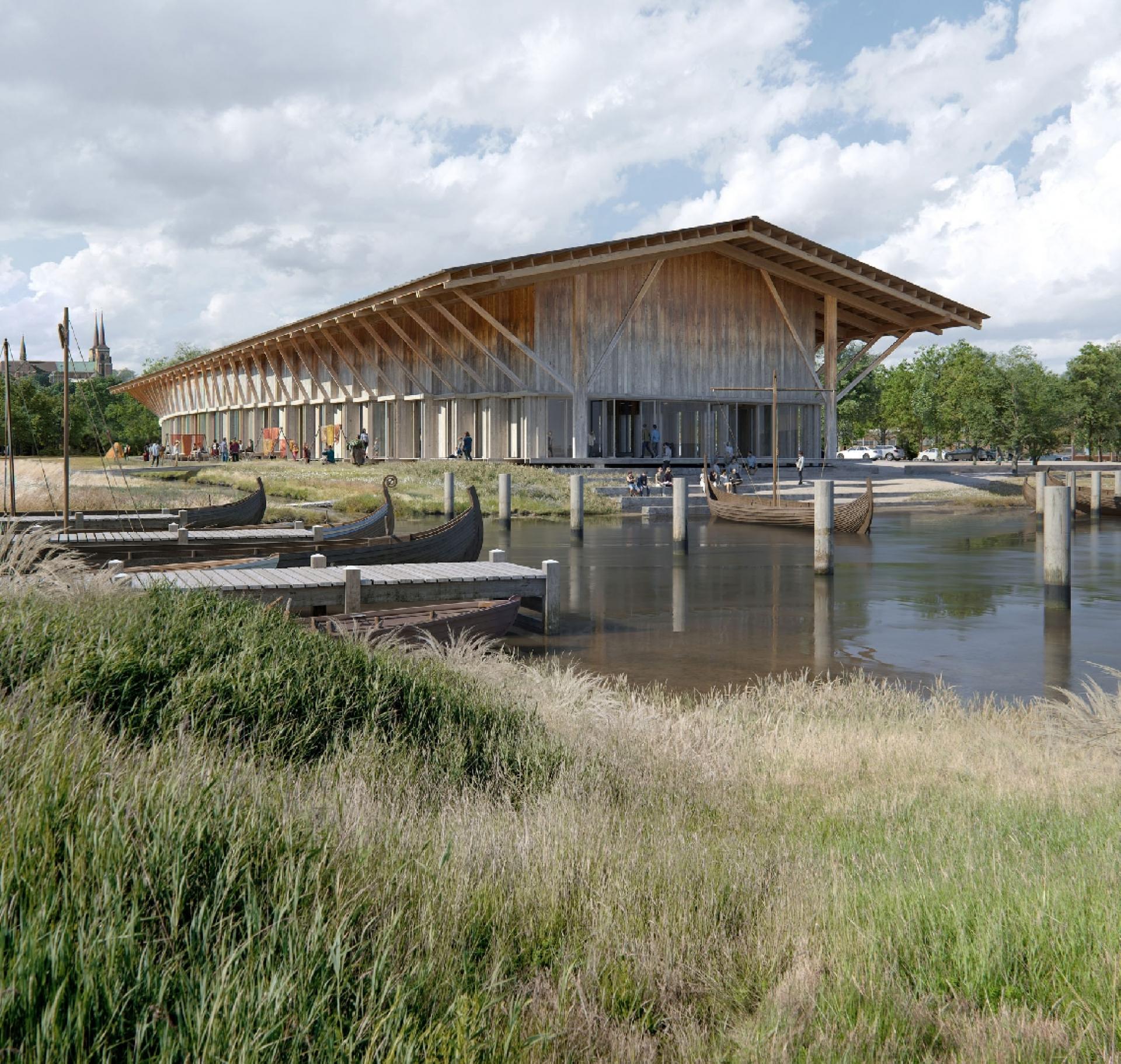 Lundgaard & Tranberg Arkitekter har valgt, at den nye museumsbygning skal være i træ. Det er et materiale, som knytter sig til fortiden med vikingetidens huse og skibe. Det skaber også forbindelse til nutidens bygninger på Museumsøen og livet på havnen. Træbygningen er tegnet ud fra idéen om, at materialet skal bruges ærligt med synlige konstruktioner og med en lige så stor byggeteknisk klarhed som ses i den eksisterende Vikingeskibshal i beton fra slutningen af tresserne. Visualisering: Lundgaard & Tranberg Arkitekter og KVANT-1